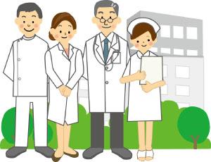 男女の医師や看護師4人が建物の前に立っているイラスト